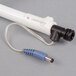 A white tube with a black cap and a blue wire.