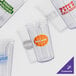 A group of empty clear GET SAN plastic tumblers.