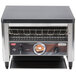 A Nemco conveyor toaster on a counter in a professional kitchen.