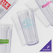 A clear plastic container filled with empty GET Spektrum tumblers.