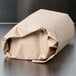 A roll of Bagcraft Packaging EcoCraft freezer paper on a stainless steel counter.