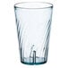 A clear plastic tumbler with a wavy design on the bottom and a blue rim.