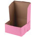 A pink bakery box with a brown lid.