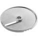 A stainless steel circular food processor disc with a blade and a hole in the center.