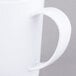 A close-up of a white Carlisle Tritan mug with a handle.