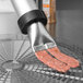 A close-up of the Weston Jerky Shooter Kit being used to prepare meat.