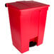 A red Rubbermaid rectangular step-on trash can with a lid and handle.