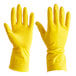 A hand wearing a yellow Cordova rubber glove.