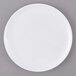 A white Carlisle melamine plate with a white rim on a gray surface.