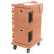 A beige Cambro insulated food pan carrier on wheels with black handles.