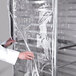 A person in a white lab coat opening a Clear Bun Pan Rack Cover.