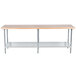 An Advance Tabco wood top work table with a galvanized base and undershelf.