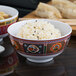 A Thunder Group Peacock melamine rice bowl filled with rice on a white background.