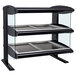 A black and silver Hatco countertop heated display case with three shelves holding trays.