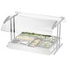 A clear plastic panel on a food tray with salad and vegetables.