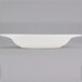 A white bowl sitting on a table.