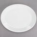 A white oval china platter with a white rim.