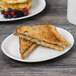 A Tuxton oval china platter with two slices of toast and berries.