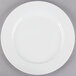 A Tuxton AlumaTux white china plate with a white rim.