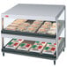 A Hatco white granite countertop food display warmer with trays of food inside.