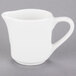 A Tuxton white china creamer with a handle.