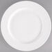 A Tuxton AlumaTux Pearl White china plate with a white rim.