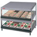 A Hatco countertop display case with food on shelves.