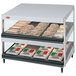 A white Hatco countertop display case with food on two shelves.