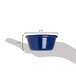 A hand holding a Carlisle cobalt blue melamine ramekin.