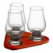 A Stolzle Glencairn whiskey tasting set on a wood tray with a stand holding three glasses.