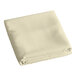 A folded ivory cloth table cover.