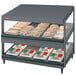 A Hatco countertop display case with food on shelves.