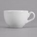 A close-up of a Tuxton Modena AlumaTux Pearl White espresso cup with a handle.