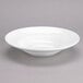 A Tuxton Modena AlumaTux Pearl White China bowl.