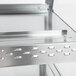 A stainless steel Hatco countertop shelf with metal handles and holes.