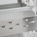 A close-up of a stainless steel Hatco countertop merchandiser shelf.