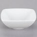 A Tuxton TuxTrendz white square china bowl on a gray background.