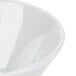 A close-up of a Tuxton TuxTrendz Linx white china bowl with a white rim.
