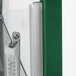 A thermometer on a green glass door with a metal handle.