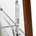 A Hatco stainless steel countertop hot food display warmer with a thermometer on a metal rack.