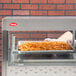 A stainless steel Hatco countertop food display warmer with trays of french fries.