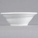 A close-up of a Tuxton Linx bright white china bowl with a small spiral rim.