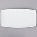 A white rectangular china tray with a circle on it.