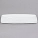 A white rectangular china tray with tapered ends.