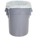 A grey trash can with a BioStar compostable trash can liner inside.