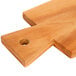 An American Metalcraft olive wood serving board with a hole in it.