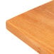 An American Metalcraft olive wood serving board on a wood surface.