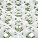 A white and green plastic Vollrath glass rack with 25 compartments.