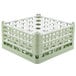 A light green plastic Vollrath glass rack with 25 compartments.