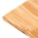 An American Metalcraft olive wood serving board on a wood surface.